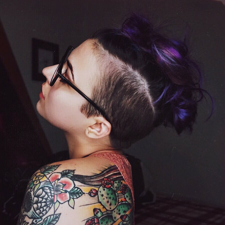 person with an undercut and dark purple hair
