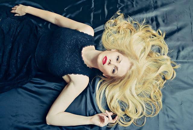 woman with blonde bleached hair lying down